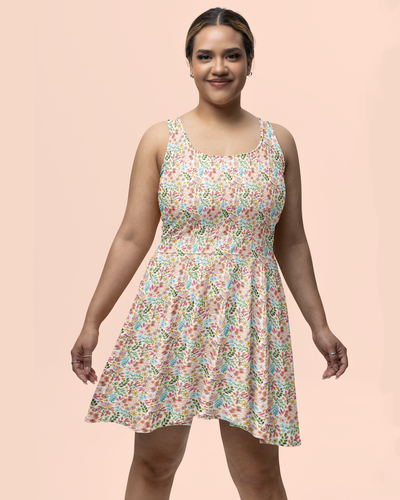 Garden Gala pastel floral sleeveless scoop neck fit and flare dress on smiling plus-size woman standing in front of a pink background