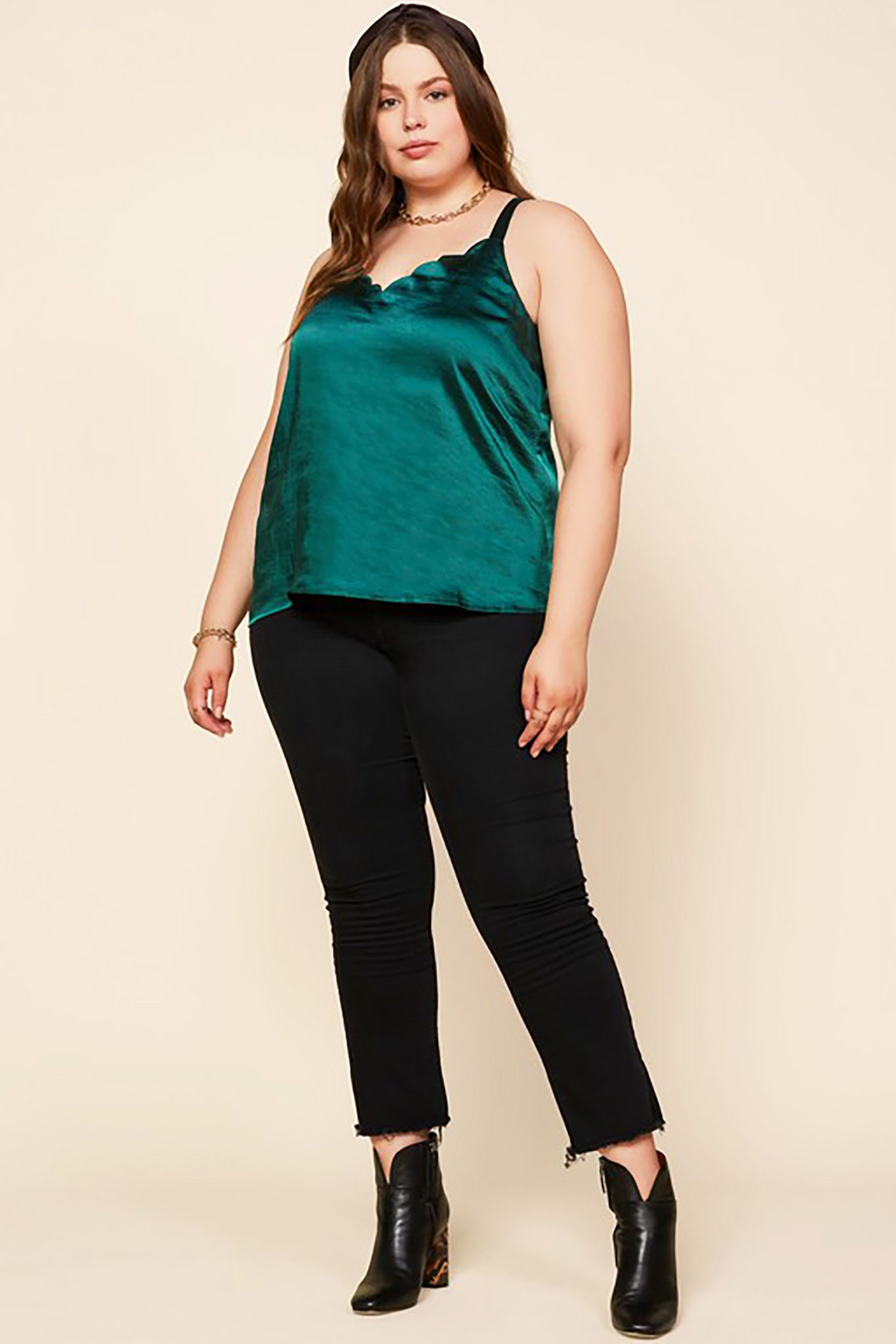Belle and Broome Joy satin scalloped cami in emerald green on model with black jeans and black boots, full outfit view