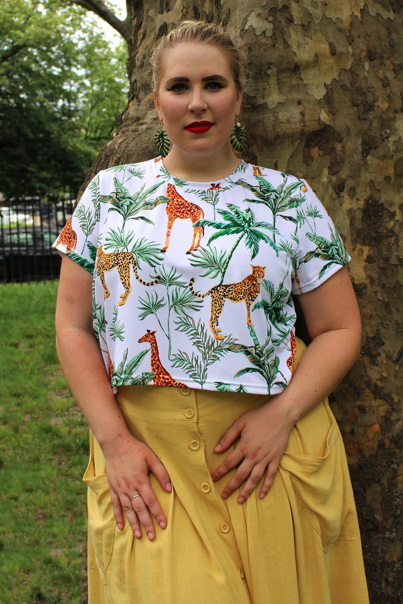 Model outside wearing jungle print crop tee with yellow skirt