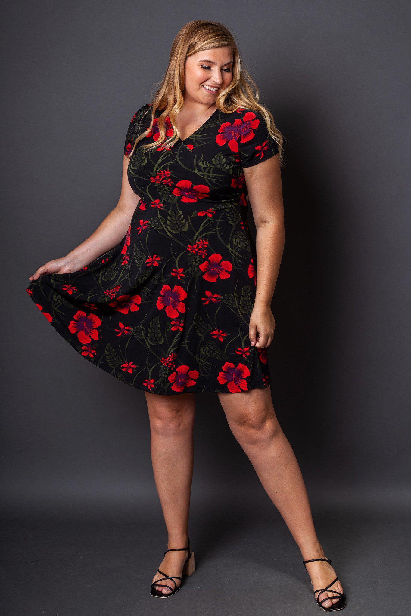 Holly Fit and Flare Floral Dress front view on model holding one side of the skirt