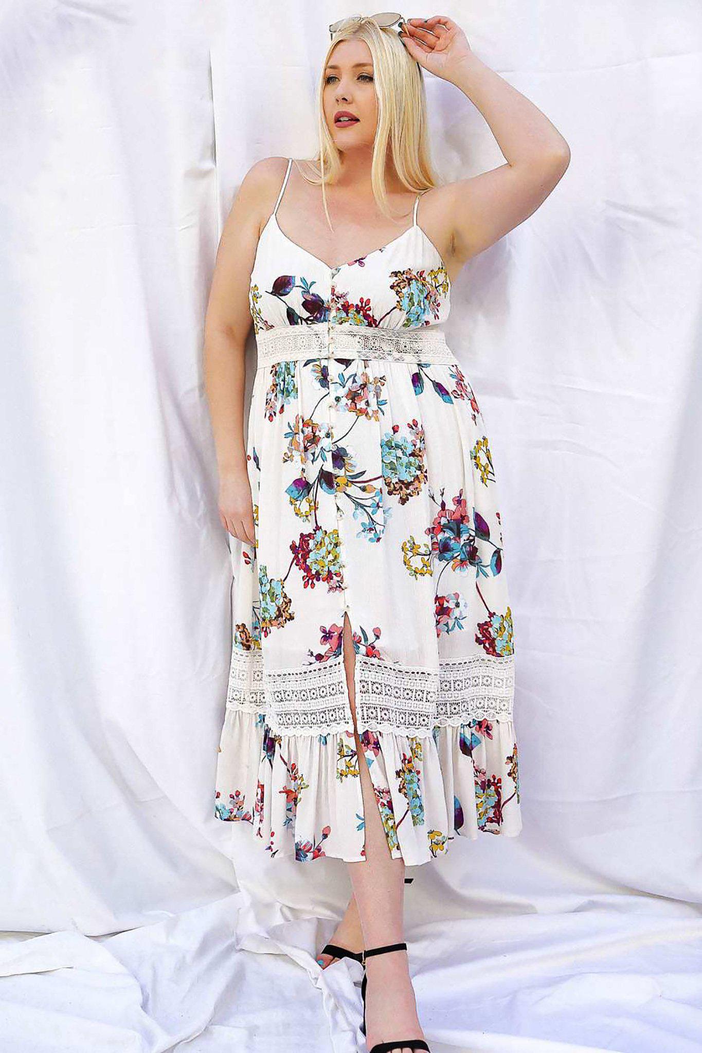 Leah Floral Midi Dress front view with leg slit showing on model with her arm up, in front of white background